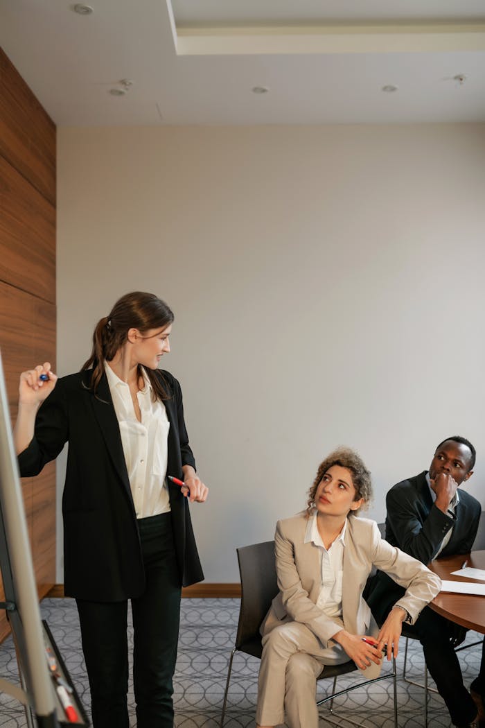 Group of diverse professionals engaging in a collaborative office meeting indoors.